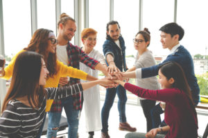 Group of people holding hands.